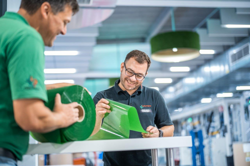 Two Lohmann employees look at the new bio-based ECO-Tape.jpg